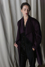 Load image into Gallery viewer, A person with short dark hair stands in front of draped fabric, wearing an aubergine Winston Long Double-face coat over a black outfit. The sophisticated double-faced cashmere accentuates their contemplative expression as they look slightly downward.