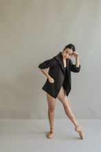 Load image into Gallery viewer, A woman dancing in the Mornington jacket, the raw-edge stitches adding a hint of casual flair.