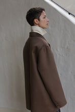 Load image into Gallery viewer, A woman wears the Sculptor&#39;s Jacket in taupe.