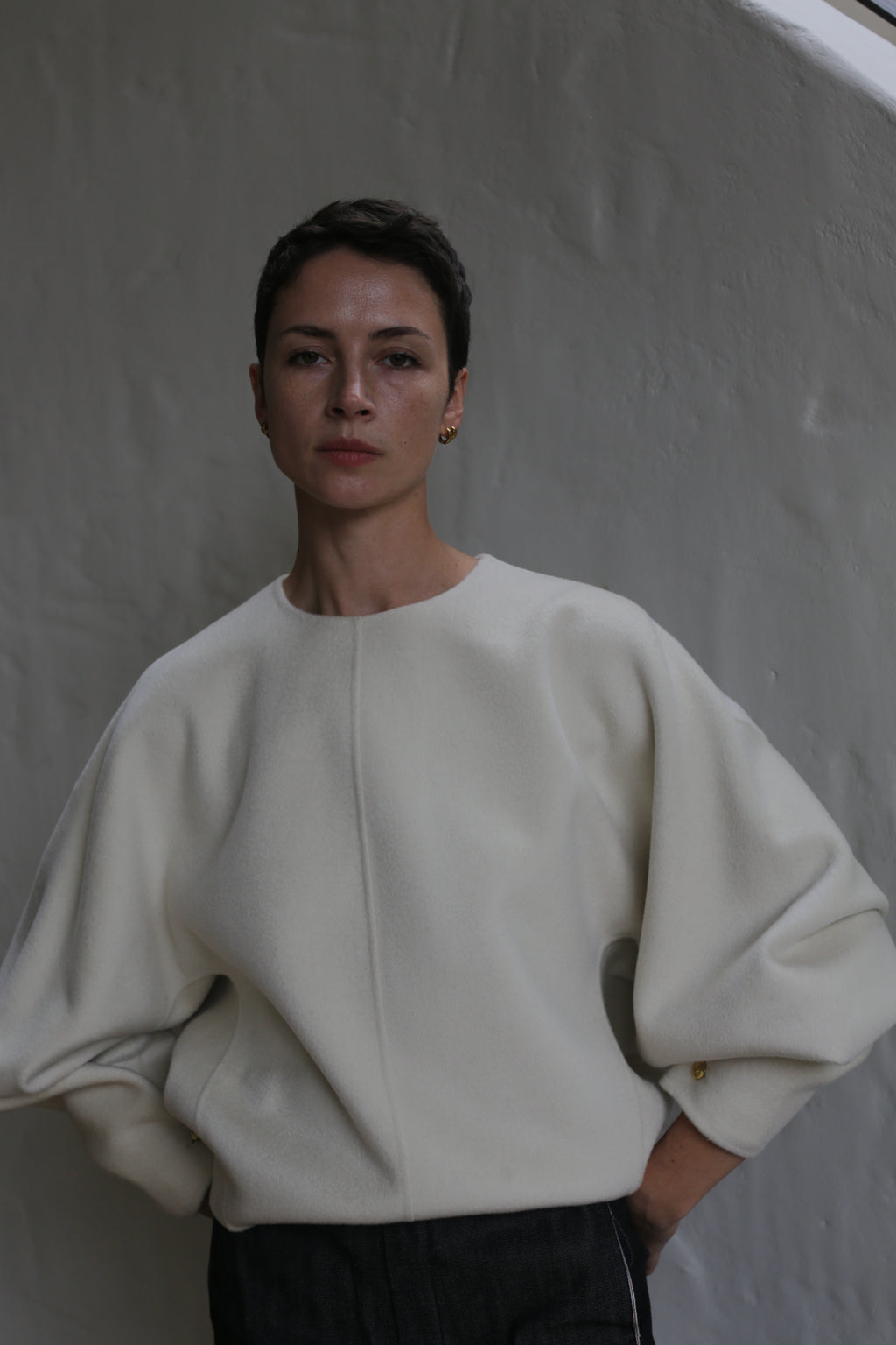 A woman wearing the Cocoon | Undyed white sweater.