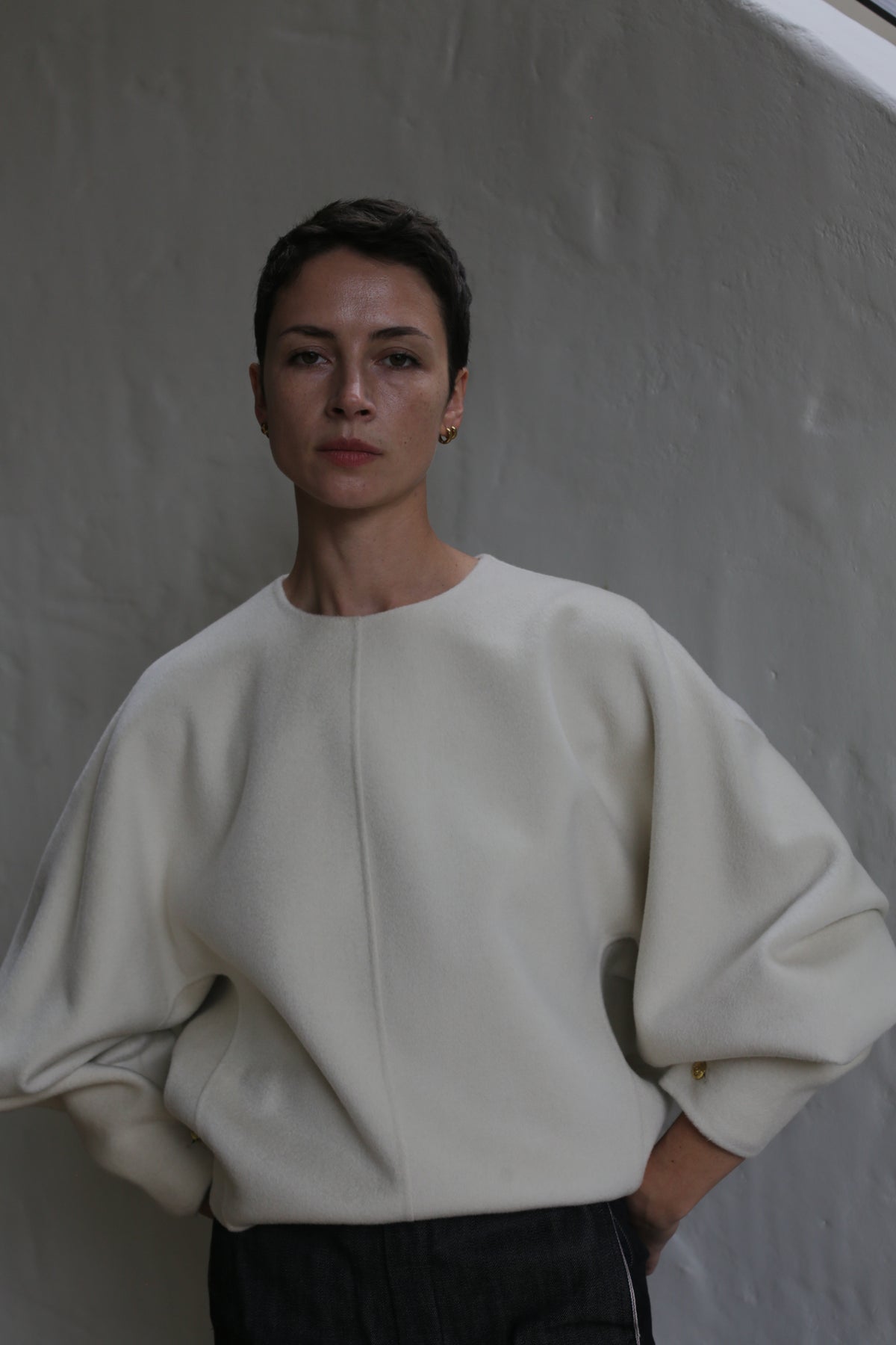 A woman wearing the Cocoon | Undyed white sweater.