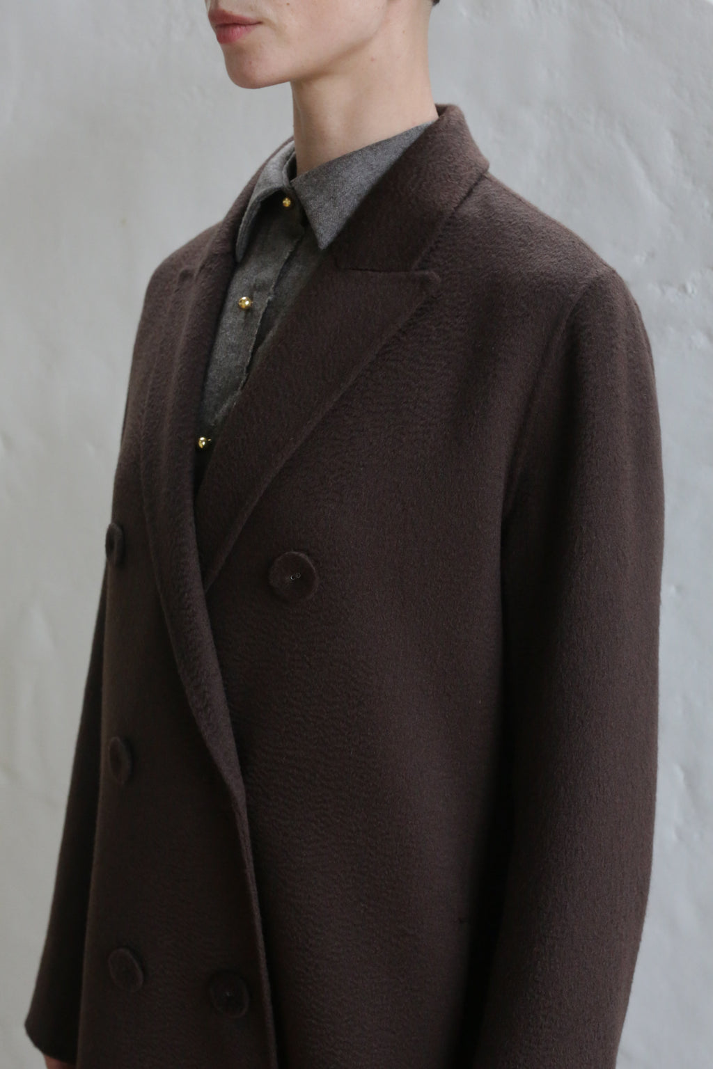 A mannequin wearing the Doublebreasted Coat in Watermark Brown.