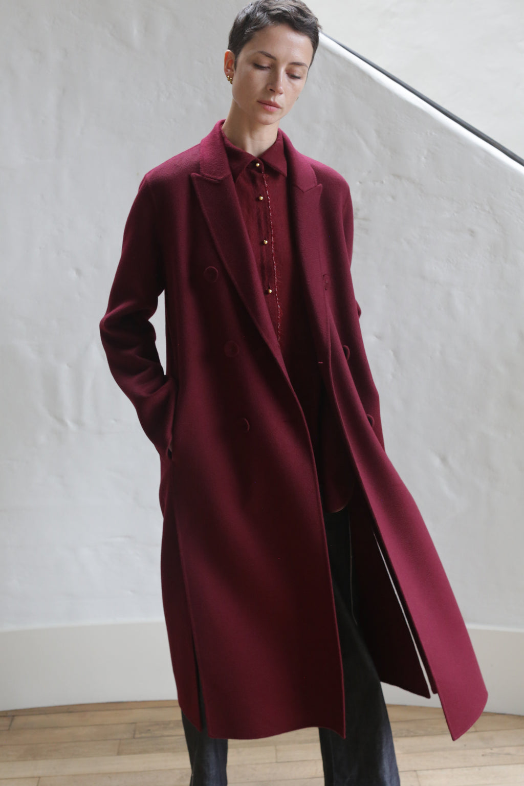 A man wearing the Doublebreasted Coat in Watermark Burgundy.