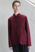A woman in the Mandarin Jacket | Watermark Burgundy.