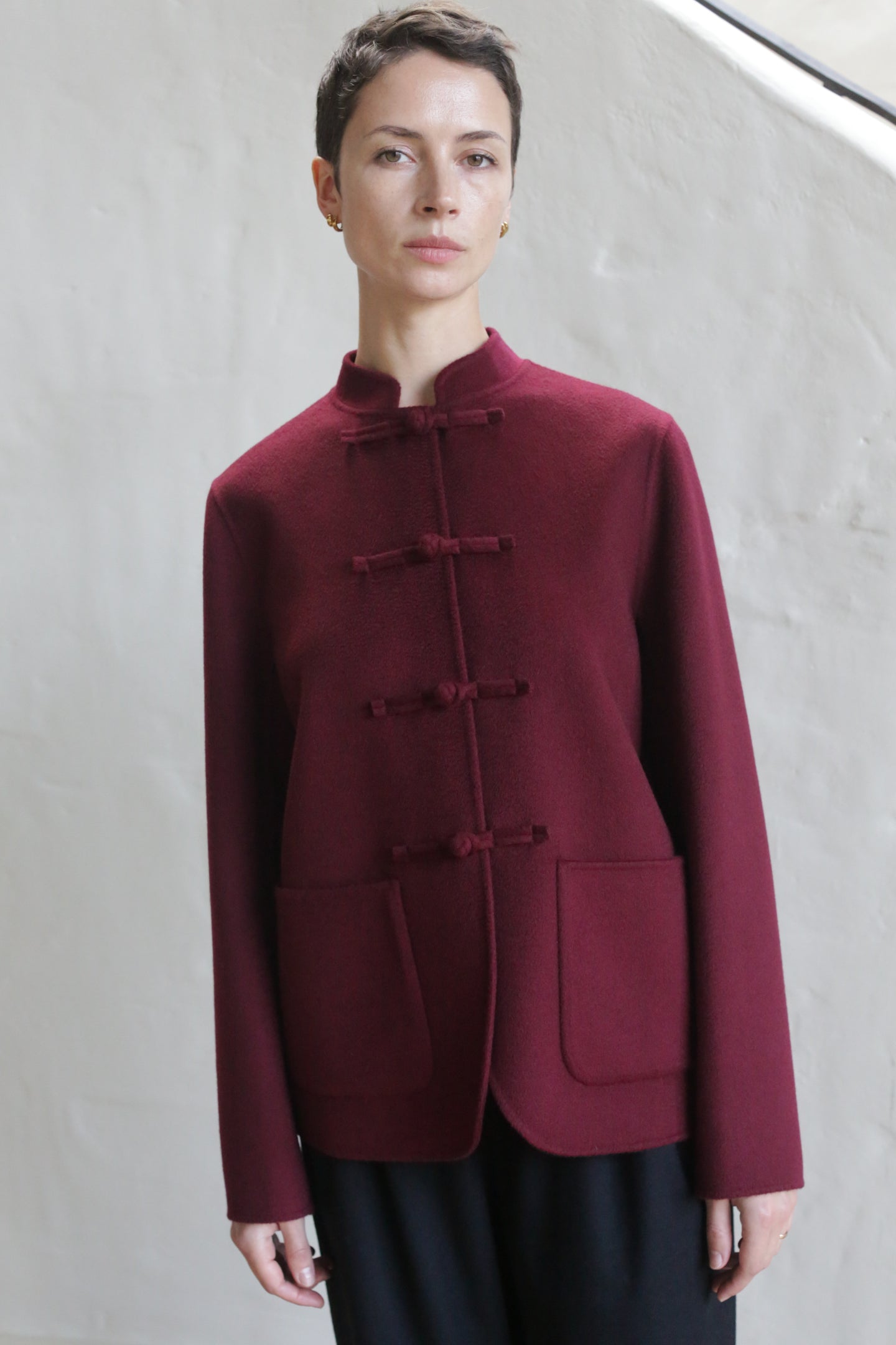 A woman in the Mandarin Jacket | Watermark Burgundy.