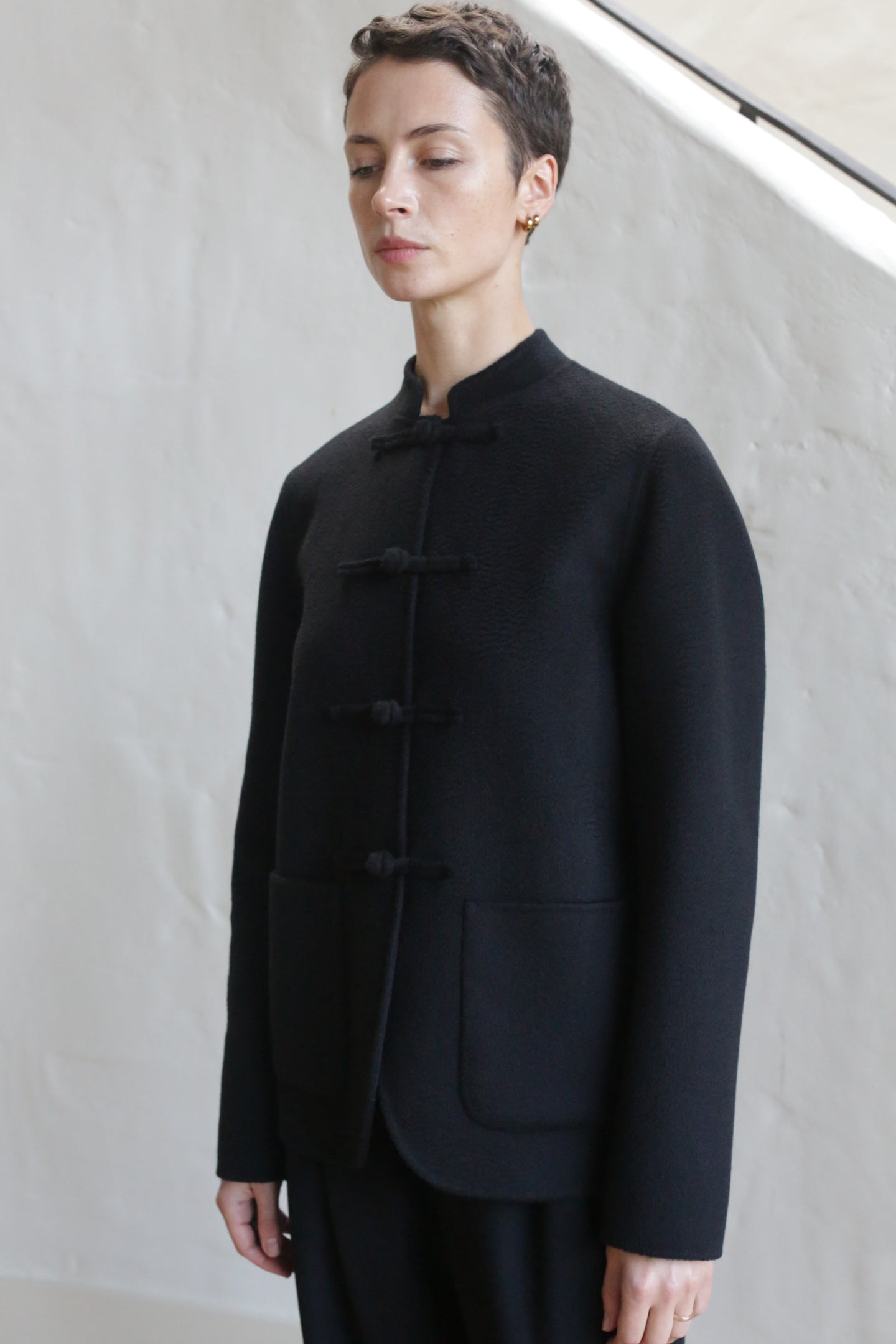 A person wearing the Mandarin Jacket in Watermark Black.