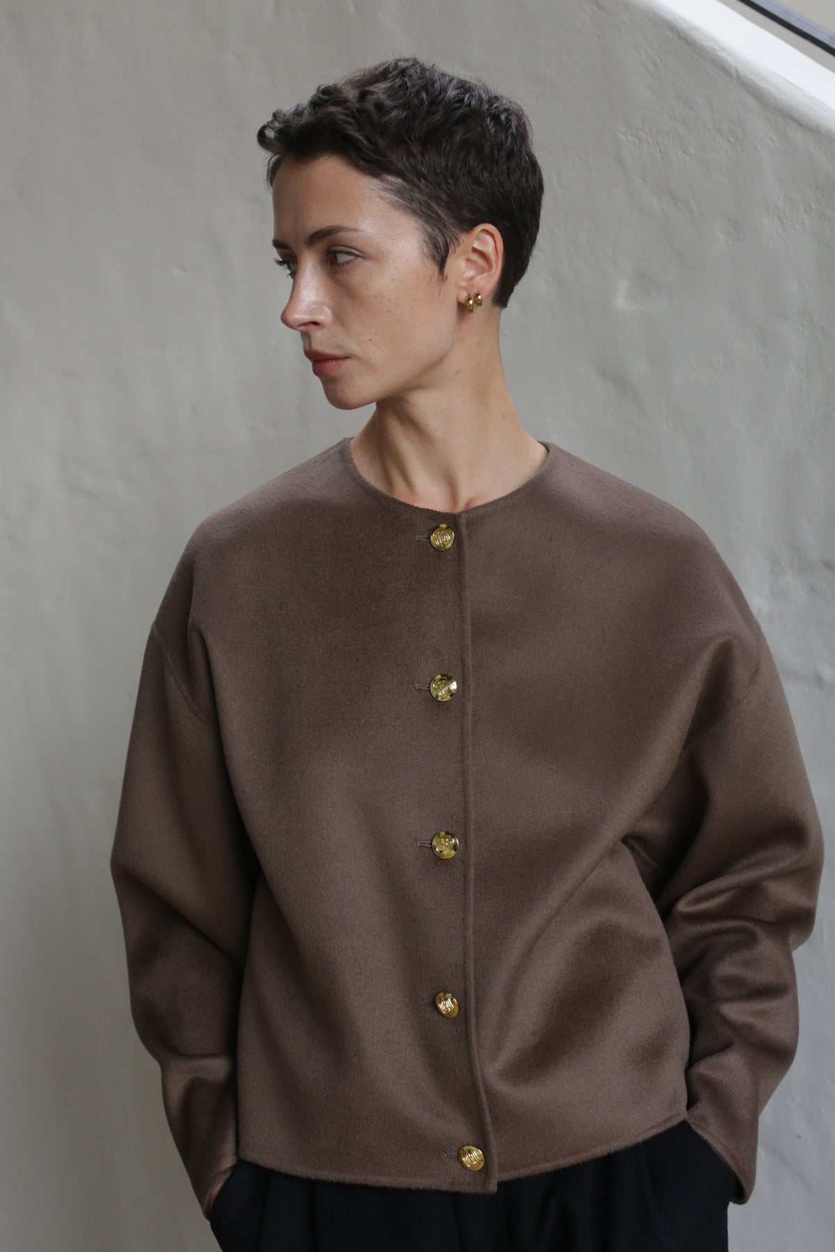 A woman in the Cocoon Jacket in taupe.