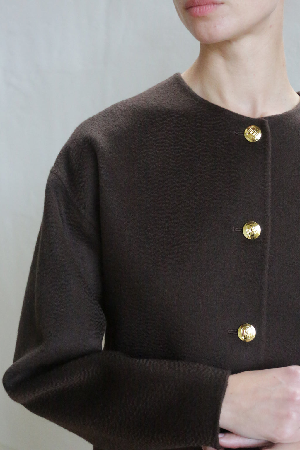 A person wearing the Cocoon Jacket in Watermark Brown.