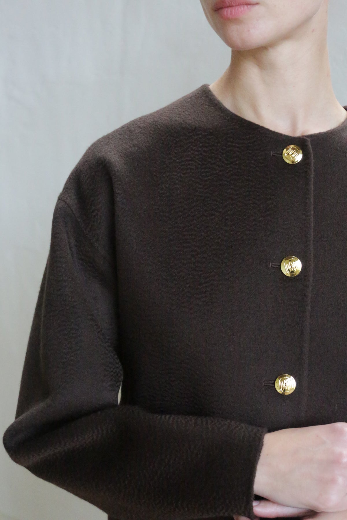 A person wearing the Cocoon Jacket in Watermark Brown.