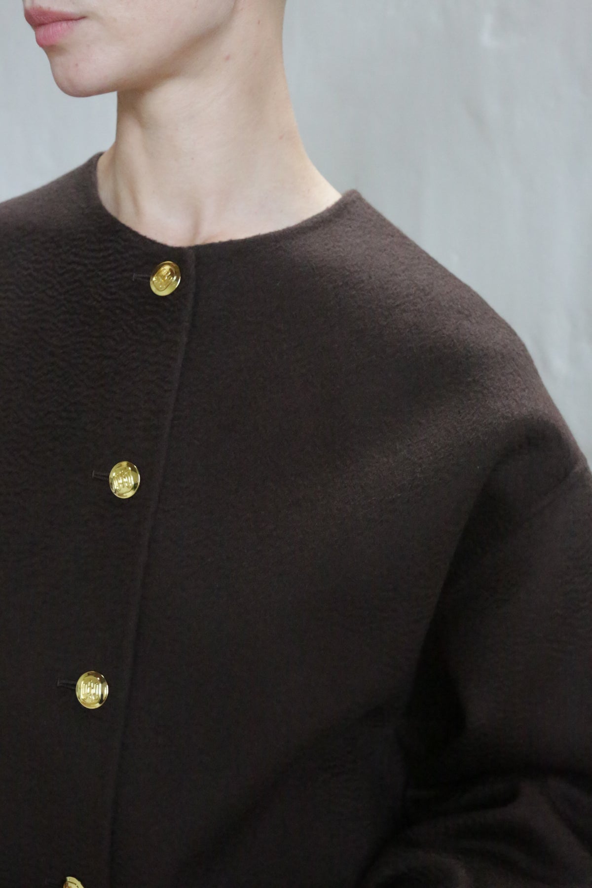 A person wearing the Cocoon Jacket in Watermark Brown.
