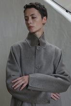 Load image into Gallery viewer, A person with short hair wearing the Men&#39;s Coat in Undyed Natural.