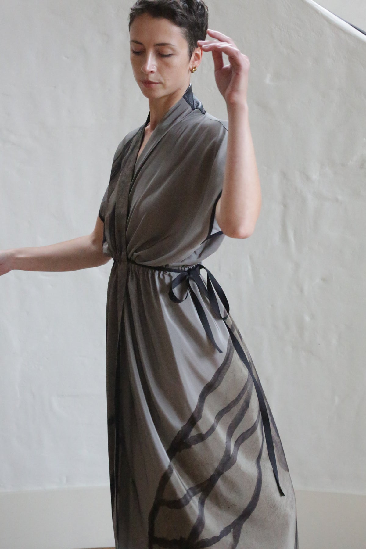 A woman wearing the Lune Dress in Butterfly Wing.