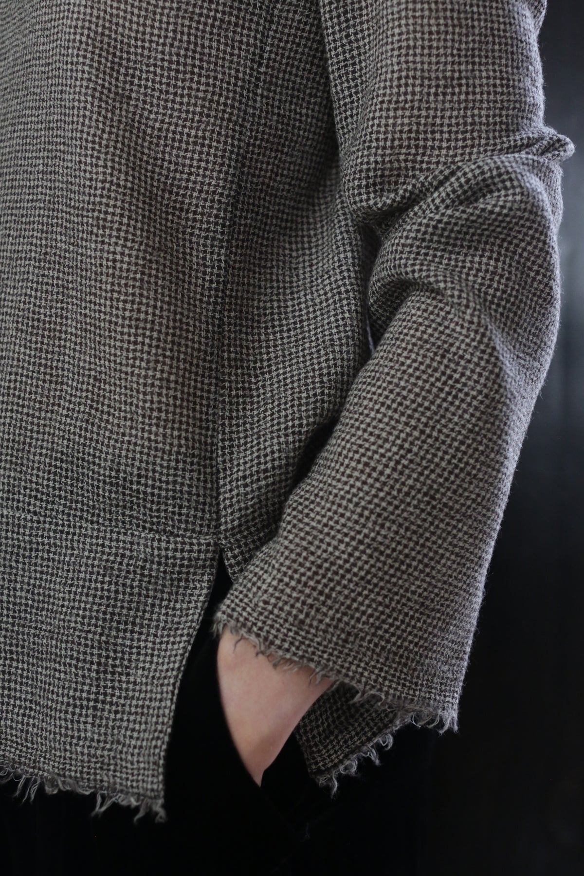A close-up of a Crewneck shirt - Japanese Wool Gauze | Brown Houndstooth. This handmade piece embodies sustainable design at its finest.