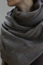 Load image into Gallery viewer, A close-up shows a person’s neck and shoulders wrapped in the Tissue Weight Cashmere Scarf in Taupe (36&quot; x 82&quot;). The face is partially out of frame, with a blurred, neutral background.