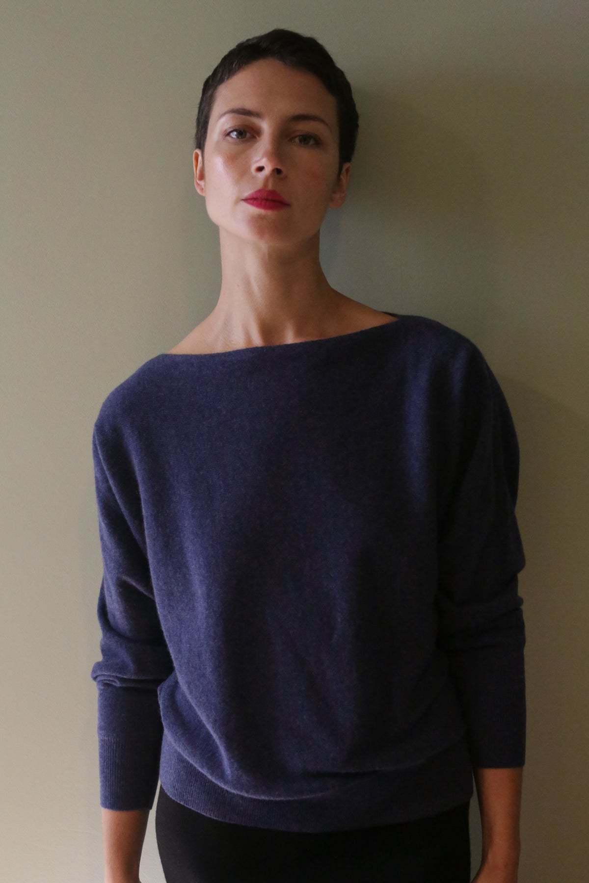 Person wearing a Ballerina’s Cashmere Sweater | Navy, featuring a boat-neck and a relaxed silhouette.