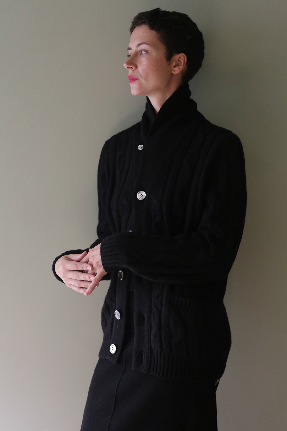 Unisex Shawl-Collar Cable-Knit Cashmere Cardigan in black featuring a shawl collar and a button front.