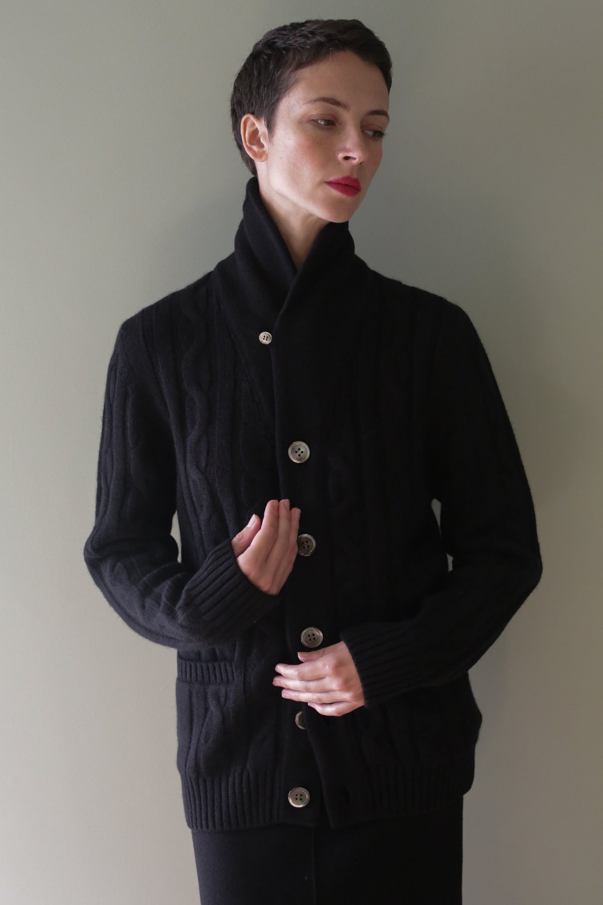 Unisex Shawl-Collar Cable-Knit Cashmere Cardigan | Black with a shawl collar and large buttons.