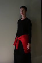 Load image into Gallery viewer, A person wearing a Cashmere Sweater Dress | Black with a red sweater tied around their waist.