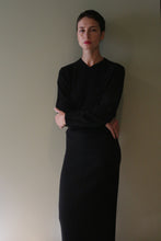Load image into Gallery viewer, A woman wearing a black long-sleeved sweater and a matching Cashmere Pencil Skirt | Black.