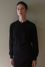 Load image into Gallery viewer, A person wears a black High V-Neck Cashmere Sweater with long sleeves.