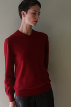 Load image into Gallery viewer, A person wearing a burgundy High V-Neck Cashmere Sweater with long sleeves.
