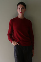 Load image into Gallery viewer, A person with short hair wears a High V-Neck Cashmere Sweater | Burgundy with one hand in their pocket.