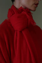 Load image into Gallery viewer, Person wearing a bright red Tissue Weight Cashmere Scarf in Vermillion, tied in a knot at the neck.
