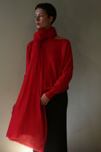 Load image into Gallery viewer, A person wearing a bright red Tissue Weight Cashmere Scarf draped over a matching red sweater.