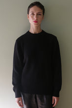 Load image into Gallery viewer, A person wearing a black Unisex Heavyweight Cashmere Crewneck sweater.