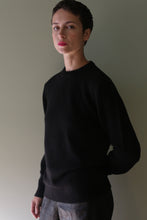 Load image into Gallery viewer, A person wearing a black Unisex Heavyweight Cashmere Crewneck sweater.