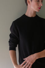 Load image into Gallery viewer, Person wearing a black Unisex Heavyweight Cashmere Crewneck sweater.