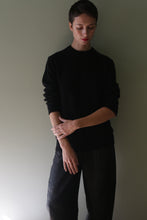 Load image into Gallery viewer, Person wearing a Unisex Heavyweight Cashmere Crewneck | Black with long sleeves and black pants.