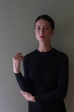 Load image into Gallery viewer, A person with short hair wearing a long-sleeved, hand-linked blue black Cropped Silk Crewneck.
