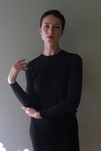 Load image into Gallery viewer, A person with short hair wearing a blue black Cropped Silk Crewneck, a long-sleeved, hand-linked silk top.