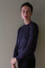 Load image into Gallery viewer, A person with short hair wearing a navy Cropped Silk Crewneck.