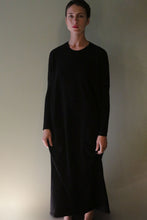 Load image into Gallery viewer, A person wearing a long-sleeved, floor-length black Cashmere Sweater Dress.