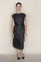 Load image into Gallery viewer, A woman with short dark hair wears the sleeveless, calf-length Futo Dress Reversible in Xiang Yun Silk Endless Bloom with black heels, standing against a plain beige background. She has a neutral expression and minimal jewelry.