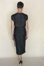 Load image into Gallery viewer, A woman with short hair, wearing black heels, faces away in a knee-length Futo Dress Reversible | Xiang Yun Silk Endless Bloom, designed for zero waste, set against a plain light background.