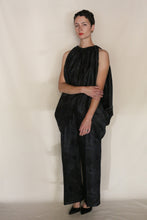 Load image into Gallery viewer, A person stands against a plain background in the Butterfly | Xiang Yun Silk Lingering Fragrance outfit—loose, sleeveless, wide-legged—wearing pointed black shoes, arms crossed, short dark hair, and a neutral expression while gazing at the camera.