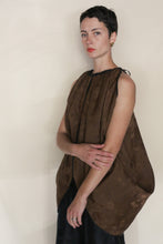Load image into Gallery viewer, A woman with short dark hair models the Butterfly | Xiang Yun Silk Lingering Fragrance top— a loose, brown reversible silk piece with a gathered neckline—standing against a neutral background and gazing seriously at the camera.