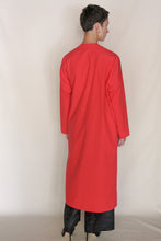 Load image into Gallery viewer, A person with short hair faces away, wearing the handmade Qipao Dresscoat | Organic Typewriter Vermilion over black pants and black shoes, set against a plain light background.