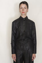 Load image into Gallery viewer, A person with short dark hair wears the Studio Shirt | Xiang Yun Silk Earth Mark with matching high-waisted pants, standing against a plain light background and looking directly at the camera with a neutral expression.