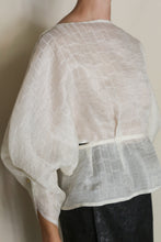 Load image into Gallery viewer, Someone wears the Origami | Silk Mesh top in sheer white with wide sleeves and a loose fit, showing its back and side. It's paired with a dark skirt against a neutral background.