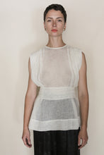 Load image into Gallery viewer, A person with short dark hair wears the Shoulder Pleat Top | Linen Leno Ivory, paired with black bottoms, standing against a plain light background and looking directly at the camera with a neutral expression.