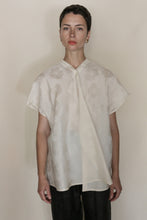 Load image into Gallery viewer, A person with short hair stands against a plain light background, wearing the handmade Qipao Vest Hidden Peony Undyed paired with black pants, looking directly at the camera with a neutral expression.