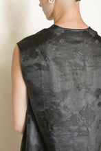 Load image into Gallery viewer, Person with short hair and a hoop earring, seen from behind, wears the V Neck Tank Reversible | Xiang Yun Silk Lingering Fragrance in black silk jacquard with a subtle floral pattern. The background is plain and light-colored.