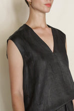 Load image into Gallery viewer, A person in a V Neck Tank Reversible | Xiang Yun Silk Faux Bois, black silk jacquard, gold hoop earrings, and short hair poses against a plain light background.