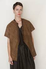 Load image into Gallery viewer, A woman with short dark hair wears the Qipao Vest Reversible | Xiang Yun Silk Faux Bois over a black dress. She stands against a plain white background, looking at the camera with a neutral expression.