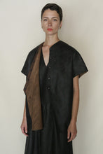 Load image into Gallery viewer, A woman with short brown hair wears a loose black dress and the Qipao Vest Reversible | Xiang Yun Silk Faux Bois, featuring brown and black panels, standing against a plain light background and looking at the camera.