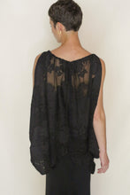 Load image into Gallery viewer, A person with short hair, wearing the Butterfly | Silk Uragiri Black top—sleeveless, black, and loose-fitting—stands facing away from the camera against a plain light background.